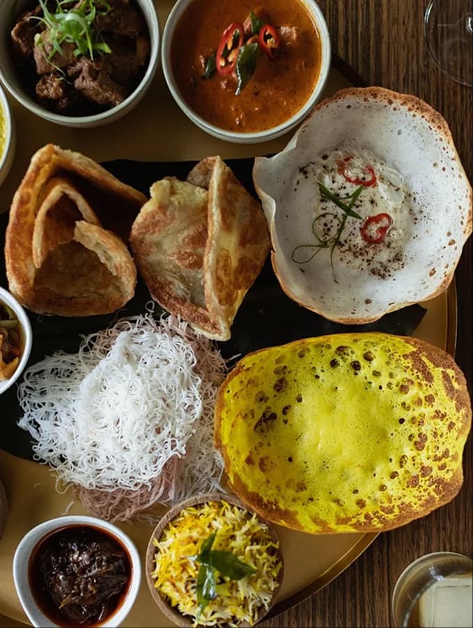 A spread of Sri Lankan curries, hoppers, and string hoppers